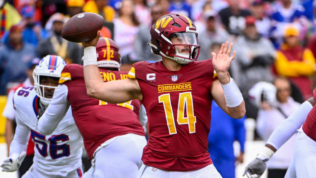 Washington Commanders quarterback Sam Howell (14)j attempts a pass against the Buffalo Bills during the first half at FedExField.